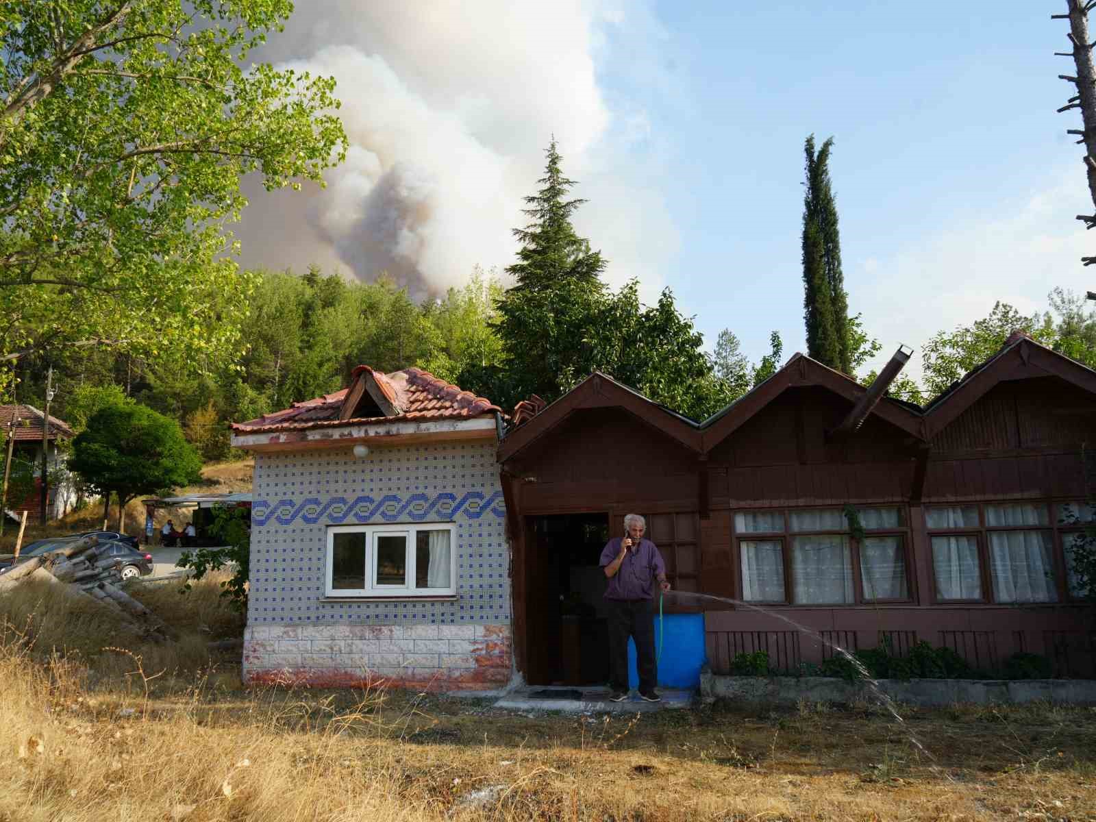 Elinde hortumla otları ıslatarak evini yangından korumaya çalıştı 